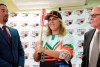 First baseman and member of the National Women's Baseball Team, Diamilette Quiles Alicea, center, is presented as the first female player to sign with The Utuado Highlanders, one of the teams that participate in the Superior Double A Baseball League, in San Juan, Puerto Rico, Thursday, May 16, 2019. Quiles Alicea shows the team's colors accompanied by the representative of the Montaneses of Utuado Rafael Juarbe, left, and the president of the Federation, Dr. Jose Quiles Rosas. (AP Photo/Carlos Giusti)