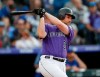 Colorado Rockies' Daniel Murphy follows the flight of his double to drive in two runs off Chicago Cubs starting pitcher Jose Quintana in the first inning of a baseball game Tuesday, June 11, 2019, in Denver. (AP Photo/David Zalubowski)