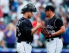 Colorado Rockies catcher Chris Iannetta, left, congratulates relief pitcher Bryan Shaw after he struck out Toronto Blue Jays' Eric Sogard for the final out in the ninth inning of a baseball game Sunday, June 2, 2019, in Denver. The Rockies won 5-1. (AP Photo/David Zalubowski)