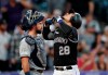 Colorado Rockies' Nolan Arenado gestures as he crosses home plate after hitting a two-run home run, next to San Diego Padres catcher Austin Hedges during the first inning of a baseball game Friday, Sept. 13, 2019, in Denver. (AP Photo/David Zalubowski)