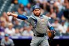 Los Angeles Dodgers catcher Russell Martin throws to first base to put out Colorado Rockies' Ian Desmond in the ninth inning of a baseball game Sunday, June 30, 2019, in Denver. (AP Photo/David Zalubowski)