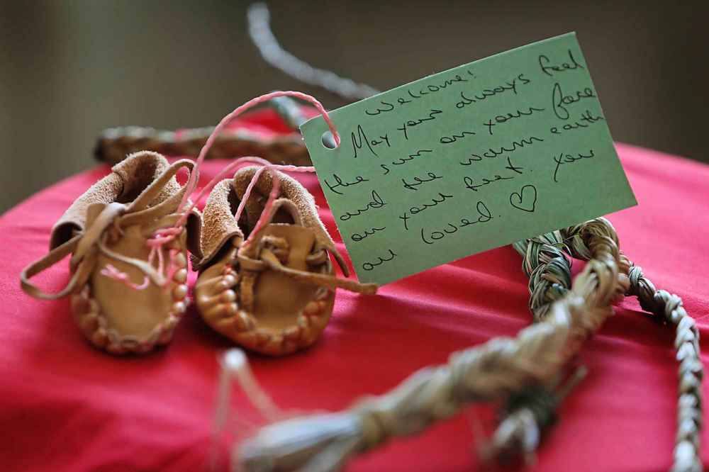 RUTH BONNEVILLE / WINNIPEG FREE PRESS
Handcrafted moccasins made by support groups wait to be given to families whose children have been taken away by CFS as a symbol of encouragement and hope.