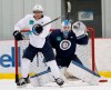Winnipeg Jets' Andrew Copp (9) tries to tip pucks past goaltender Eric Comrie (1) during practice in Winnipeg, Monday, April 8, 2019. Goalie Eric Comrie and the Winnipeg Jets agreed to a two-year deal on Saturday with an average annual value of $700,000 in the NHL. THE CANADIAN PRESS/John Woods