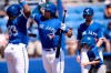 Toronto Blue Jays' Vladimir Guerrero Jr., left, and Bo Bichette, right, celebrate after Bichette's two-run home run during the first inning of a spring training baseball game against the Canada Junior National Team Saturday, March 17, 2018, in Dunedin, Fla. Vladimir Guerrero Jr. and Bo Bichette are among the 15 players announced as non-roster invitees to the Blue Jays' major league spring training camp. THE CANADIAN PRESS/AP, Jason Behnken