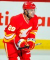 Calgary Flames' Akim Aliu, from Nigeria, celebrates his first NHL goal during first period NHL hockey action against the Anaheim Ducks in Calgary, Alta., Saturday, April 7, 2012. Aliu tweeted on Monday night that he had a racial slur directed his way by a former coach in 2009-10 while a member of the American Hockey League's Rockford IceHogs. THE CANADIAN PRESS/Jeff McIntosh