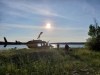 Officers look through a remote lake area alongside a landed helicopter in the Gillam, Man., area in July 28, 2019, police image published to social media. The chief of a remote northern Manitoba Indigenous community says a massive police manhunt there for two young British Columbia homicide suspects has ended, although residents have been asked to remain vigilant.  THE CANADIAN PRESS/HO-Twitter, Royal Canadian Mounted Police, @rcmpmb, *MANDATORY CREDIT*