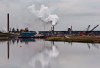 The Syncrude oil sands extraction facility is reflected in a tailings pond near the city of Fort McMurray, Alta., on June 1, 2014. Canadian environment groups are at the global climate change conference in Poland today calling out the federal government for allowing the oil and gas industry to systematically weaken Canada's efforts to be a climate leader. Environmental Defence and Stand Earth are among the groups releasing a report which shows emissions from the oil and gas sector continue to rise and intensive lobbying from the industry means about 80 per cent of those emissions will be exempt from the carbon price. THE CANADIAN PRESS/Jason Franson