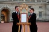 Footmen Stephen Kelly and Sarah Thompson bring out the easel in the forecourt of Buckingham Palace to formally announce the birth of a baby boy to Britain's Prince Harry and Meghan, the Duchess of Sussex, in London, Monday, May 6, 2019. THE CANADIAN PRESS/AP-PA, Yui Mok