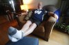 Winnipeg Blue Bombers' fan Chris Matthew, who has been wearing shorts daily since the 2001 Grey Cup in Calgary, relaxes in his living room in Winnipeg Wednesday, November 20, 2019. With the Blue Bombers' decisive 33-12 win over Hamilton in the 107th Grey Cup, Matthew is due for a wardrobe upgrade after 18 years and told CTV News he has plans to go shopping. THE CANADIAN PRESS/John Woods