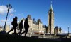 People walk near Parliament Hill in Ottawa on Wednesday, Oct. 23, 2019. Big business is adding its voice to a broader call for economy-lifting changes in Canada following an election campaign widely criticized for its dearth of deep policy discussion. THE CANADIAN PRESS/Sean Kilpatrick