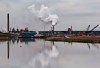 The Syncrude oil sands extraction facility is reflected in a tailings pond near the city of Fort McMurray, Alberta on June 1, 2014. Canada would have to cut its emissions almost in half over the next 12 years to meet the stiffer targets dozens of international climate change experts say is required to prevent catastrophic climate changes from the planet getting too warm. The United Nations Intergovernmental Panel on Climate Change says there will be irreversible changes and the entire loss of some ecosystems if the world doesn't take immediate and intensive action to cut greenhouse gas emissions far more than we are now. THE CANADIAN PRESS/Jason Franson