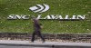 A man walks past the headquarters of SNC-Lavalin in Montreal on November 6, 2014. THE CANADIAN PRESS/Paul Chiasson