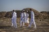 Nurses walk to collect materials, under the instruction of investigators, at the scene where the Ethiopian Airlines Boeing 737 Max 8 crashed shortly after takeoff on Sunday killing all 157 on board, near Bishoftu, or Debre Zeit, south of Addis Ababa, in Ethiopia Tuesday, March 12, 2019. THE CANADIAN PRESS/AP-Mulugeta Ayene