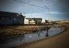 Indigenous children play in water-filled ditches in Attawapiskat, Ont. on April 19, 2016. Federal lawyers will be in court later this morning to argue the government's appeal of a Canadian Human Rights Tribunal ruling that ordered Ottawa to pay billions of dollars in compensation to First Nations children and their families. THE CANADIAN PRESS/Nathan Denette