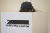 A voter marks a ballot behind a privacy barrier in the riding of Vaudreuil-Soulanges, west of Montreal, on election day, Monday, Oct. 19, 2015. Pre-election polls finding that Canadians aren't particularly enthusiastic about their choices suggest the political axiom that campaigns matter will be particularly true this time. THE CANADIAN PRESS/Graham Hughes