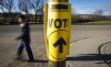 A voter walks past a sign directing voters to a polling station for the Canadian federal election in Cremona, Alta., Monday, Oct. 19, 2015. Welcome to the official start of the federal election campaign, which comes with some obvious questions about party promises and platforms, but also some others that seem to come up each time the country votes.THE CANADIAN PRESS/Jeff McIntosh