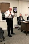 FILE - In this Nov. 14, 2018 file photo, East Hampton, Conn., Police Chief Dennis Woessner addresses the Town Council in East Hampton. East Hampton officer Kevin P. Wilcox, has retired from the force after Committee for Civil Rights Under Law raised concerns about his membership with the Proud Boys, a far-right group known for engaging in violent clashes at political rallies. In September, Woessner told the civil rights organization that Wilcox‚Äôs Proud Boys membership didn‚Äôt violate department policies. (Jeff Mill/The Middletown Press via AP)