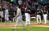Kansas City Royals starting pitcher Glenn Sparkman, left, walks off the field after being ejected by home plate umpire Mark Carlson for hitting Chicago White Sox's Tim Anderson with a pitch during the second inning of a baseball game Wednesday, May 29, 2019, in Chicago. (AP Photo/Charles Rex Arbogast)
