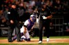 Chicago White Sox's Yoan Moncada, right, watches his two-run home run as Texas Rangers catcher Jeff Mathis, center, and home plate umpire Sam Holbrook, left, look on during the sixth inning of a baseball game Friday, Aug. 23, 2019, in Chicago. (AP Photo/Jeff Haynes)