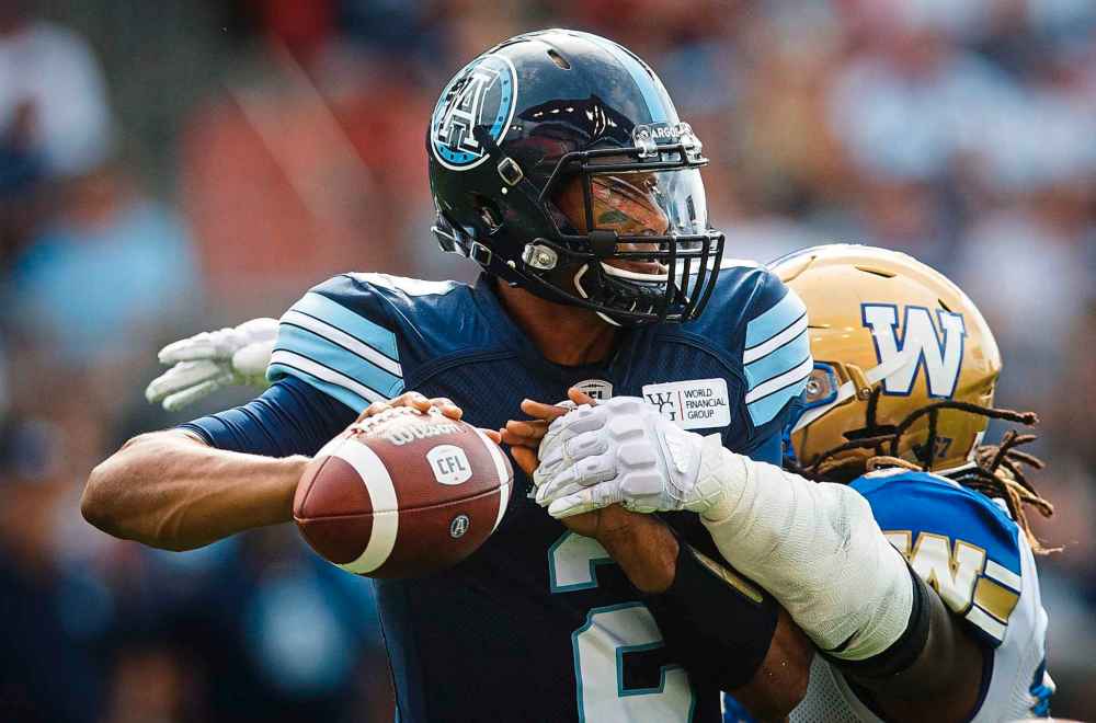 Toronto Argonauts quarterback James Franklin passes under pressure from Winnipeg Blue Bombers' Cory Johnson during last Saturday's game. (Mark Blinch / The Canadian Press files)