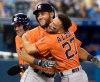 Houston Astros' Abraham Toro is embraced by teammate Jose Altuve after hitting a two-run home run against the Toronto Blue Jays in the ninth inning of their American League MLB baseball game in Toronto on Sunday, September 1, 2019. THE CANADIAN PRESS/Fred Thornhill