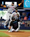 Miami Marlins' Jorge Alfaro (38) beats the throw to New York Mets second baseman Robinson Cano (24) to steal second in the fourth inning during a baseball game, Saturday, May 18, 2019, in Miami. (AP Photo/Lynne Sladky)
