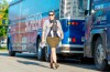 Principal Secretary to Federal Conservative Leader Andrew Scheer, Kenzie Potter and her 9-week-old baby Georgia Hubick walk past the campaign buses in Saint-Hyacinthe, Que., on Thursday, Sept. 19, 2019. THE CANADIAN PRESS/Frank Gunn