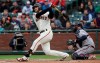 San Francisco Giants' Evan Longoria watches his RBI double in front of Atlanta Braves catcher Brian McCann during the first inning of a baseball game in San Francisco, Tuesday, May 21, 2019. (AP Photo/Jeff Chiu)