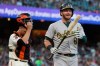Oakland Athletics' Robbie Grossman, right, reacts after striking out, next to San Francisco Giants catcher Buster Posey during the third inning of a baseball game in San Francisco, Tuesday, Aug. 13, 2019. (AP Photo/Jeff Chiu)