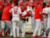 St. Louis Cardinals catcher Yadier Molina, center, is mobbed by teammates after hitting a winning sacrifice fly to score Kolten Wong and defeat the Atlanta Braves in the 10th inning of Game 4 of a baseball National League Division Series, Monday, Oct. 7, 2019, in St. Louis. (Curtis Compton/Atlanta Journal-Constitution via AP)