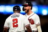Atlanta Braves' Ender Inciarte shouts as coach Eric Young talks to him after Inciarte hit an RBI single during the seventh inning of the team's baseball game against the New York Mets, Wednesday, Aug.14, 2019, in Atlanta. (AP Photo/John Amis)