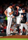 Atlanta Braves pitcher Jesse Biddle, left, talks with catcher Brian McCann as pitching coach Rick Kranitz approaches the mound after a wild pitch in which St. Louis Cardinals' Kolten Wong scored during the fifth inning of a baseball game Tuesday, May 14, 2019, in Atlanta. (AP Photo/John Amis)