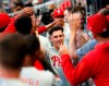 Philadelphia Phillies' Scott Kingery is greeted in the dugout after hitting a solo home run in the fourth inning of the team's baseball game against the Atlanta Braves on Friday, June 14, 2019, in Atlanta. (AP Photo/John Bazemore)