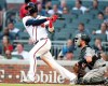 Atlanta Braves' Adeiny Hechavarria, left, singles in a run as Miami Marlins catcher Bryan Holiday looks on during the second inning of a baseball game Thursday, Aug. 22, 2019, in Atlanta. (AP Photo/Tami Chappell)