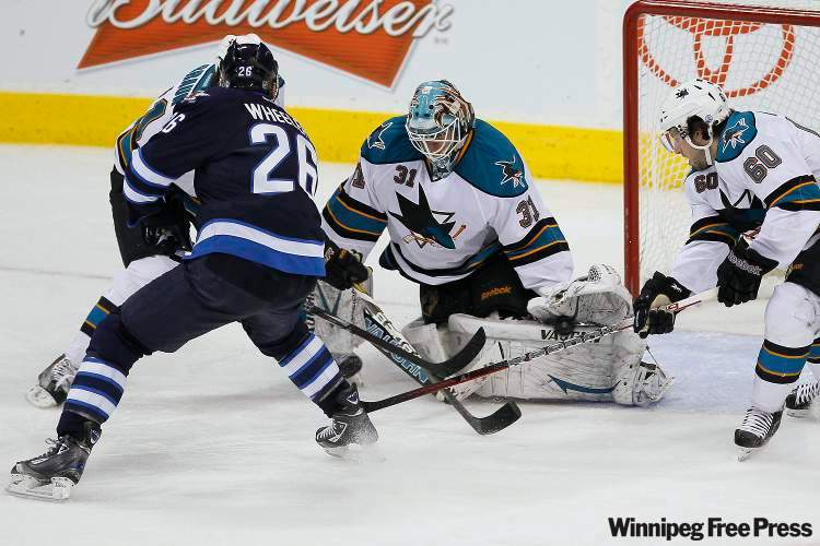 John Woods / Canadian Press
San Jose Sharks' goaltender Antti Niemi (31) saves the shot from Winnipeg Jets' Blake Wheeler (26) as Sharks' Justin Braun (61) and Jason Demers (60) cover the rebound during second period NHL action in Winnipeg on Thursday.