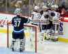 CP
Edmonton Oilers' Milan Lucic (27), Ryan Nugent-Hopkins (93), Leon Draisaitl (29) and Connor McDavid (97) celebrate after McDavid scored on Winnipeg Jets goaltender Connor Hellebuyck (37) during third period NHL hockey action in Winnipeg, Tuesday, October 16, 2018. THE CANADIAN PRESS/Trevor Hagan