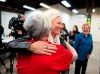 Re-elected Liberal MP Catherine McKenna hugs a member of her team after speaking to reporters after a misogynistic slur was spray painted on her image on the window, in Ottawa, on Thursday, Oct. 24, 2019. THE CANADIAN PRESS/Justin Tang