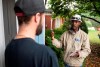 Abdul Abdi, Conservative candidate for Ottawa West-Nepean, speaks with a resident as he goes campaigning door to door in Ottawa on Saturday, Sept. 28, 2019. THE CANADIAN PRESS/Justin Tang