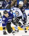 Chris O'Meara / The Associated Press
Tampa Bay Lightning centre Steven Stamkos (91) is knocked down by Winnipeg Jets defenceman Johnny Oduya, of Sweden, during the first period of an NHL hockey game on Saturday, Oct. 29, 2011, in Tampa, Fla. (AP Photo/Chris O'Meara)