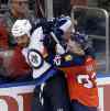 Alan Diaz / The Associated Press
Florida Panthers Kyle Rau, right,  checks Winnipeg Jets defenseman Dustin Byfuglien, left, during the second period of an NHL hockey game, Saturday.