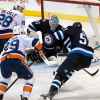 PHIL HOSSACK / WINNIPEG FREE PRESS Winnipeg Jets Connor Hellebuyck's keeps an eye on a loose puck in traffic through the crease.