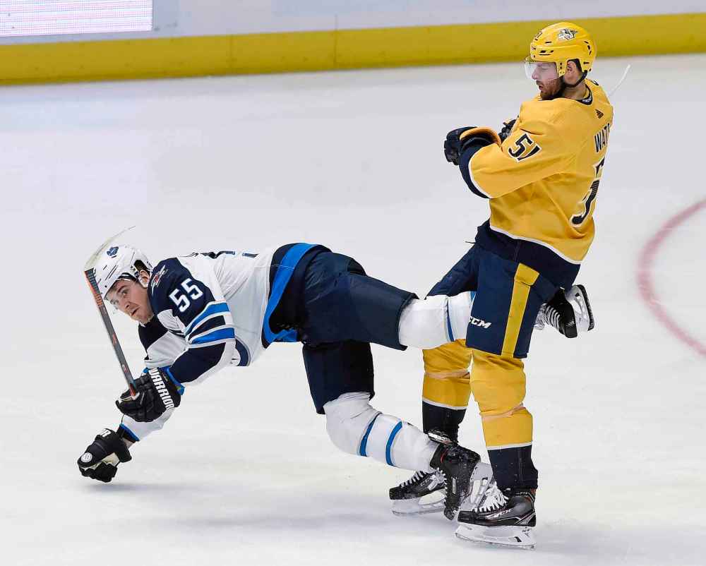 (AP Photo/Mark Zaleski)
Winnipeg Jets centre Mark Scheifele falls to the ice in front of Nashville Predators left wing Austin Watson during the first period.