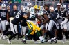 Green Bay Packers' Tra Carson (32) makes yards as Oakland Raiders' Erik Harris (25) attempts the tackle during the first half of NFL pre-season action in Winnipeg Thursday, August 22, 2019. THE CANADIAN PRESS/John Woods