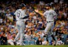 San Diego Padres' Eric Hosmer, right, is congratulated by Manny Machado as he scores on a double by Josh Naylor during the sixth inning of the team's baseball game against the Los Angeles Dodgers on Friday, Aug. 2, 2019, in Los Angeles. (AP Photo/Mark J. Terrill)