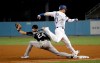 Los Angeles Dodgers' Justin Turner, right, is safe at first base on a fielder's choice next to Colorado Rockies first baseman Ryan McMahon during the third inning of a baseball game Wednesday, Sept. 4, 2019, in Los Angeles. (AP Photo/Marcio Jose Sanchez)