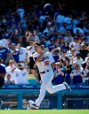 Los Angeles Dodgers' Will Smith tosses his helmet before scoring after hitting a two-run walkoff home run during the ninth inning of a baseball game against the Colorado Rockies, Sunday, June 23, 2019, in Los Angeles. (AP Photo/Mark J. Terrill)