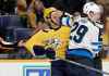 CP
Nashville Predators defenseman Dan Hamhuis, left, gets pulled away from Winnipeg Jets right wing Patrik Laine Thursday in Nashville.
