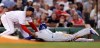 Boston Red Sox third baseman Rafael Devers, left, tags out Kansas City Royals' Billy Hamilton, right, who tried to advance to third on a flyout during the fourth inning of a baseball game at Fenway Park in Boston, Wednesday, Aug. 7, 2019. (AP Photo/Charles Krupa)