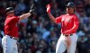 Boston Red Sox's Christian Vazquez, left, and Rafael Devers high-five after scoring on an Xander Bogaerts two RBI single during the second inning of a baseball game against the San Francisco Giants at Fenway Park in Boston, Thursday, Sept. 19, 2019. (AP Photo/Charles Krupa)