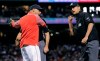 Boston Red Sox manager Alex Cora, left, is ejected by umpire Vic Carapazza, right, after arguing the ejection of Andrew Benintendi during the fifth inning of a baseball game against the Texas Rangers at Fenway Park in Boston, Tuesday, June 11, 2019. (AP Photo/Charles Krupa)
